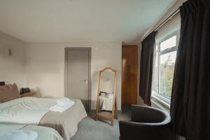 a hotel room with a bed and a mirror at Old Mill Hotel & Lodge in Bath