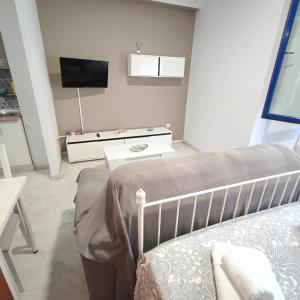 a bedroom with a bed and a tv in a room at Apartamento FIBES edificio LUX SEVILLA in Seville