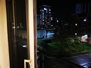 a window with a view of a city at night at City Centre Comfort in Southampton