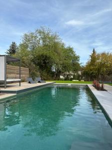 a swimming pool with blue water in a yard at Stadtvilla mit Pool in Jestetten