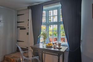 a table with a bowl of fruit in front of a window at Old Chelsea in Deal