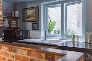 a kitchen with a sink and a window at Old Chelsea in Deal +22 photos