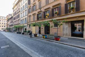Augusto Imperatore by Rental in Rome في روما: شخص يمشي في شارع مجاور للمباني