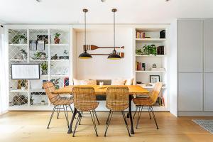 a dining room with a wooden table and chairs at Slick apartment In Quaint Battersea Square in London