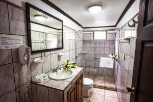 a bathroom with a sink and a toilet and a mirror at Mar Inn Costa Rica in Monteverde Costa Rica