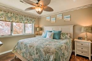 a bedroom with a bed and a ceiling fan at Lakefront Branson Condo, Near Silver Dollar City! in Branson