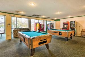 a game room with two pool tables and an arcade at Lakefront Branson Condo, Near Silver Dollar City! in Branson