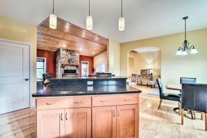 a kitchen and dining room with a table and chairs at Cozy Home with Patio, 2 Mi to Dale Hollow Lake! in Frogue