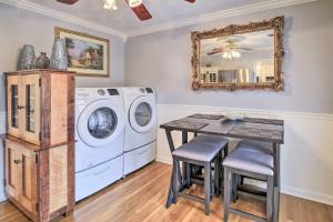 a laundry room with a washing machine and a table at Bristol Retreat with Creek Access 2 Mi to Dtwn in Bristol