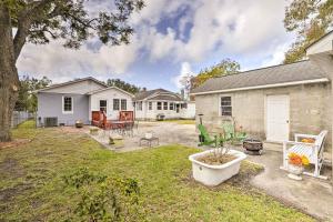 a backyard with a house and a yard with a patio at Charming Beaufort Getaway Walk to the Waterfront! in Beaufort