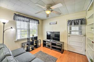 a living room with a couch and a flat screen tv at Charming Beaufort Getaway Walk to the Waterfront! in Beaufort