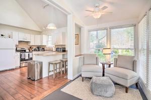 a kitchen with two chairs and a table and a counter at Cozy Home with Yard about 9 Mi to Dtwn Charleston! in Charleston