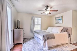 a bedroom with a bed and a ceiling fan at Cozy Home with Yard about 9 Mi to Dtwn Charleston! in Charleston