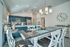 a kitchen with a table and a clock on the wall at Home in The Villages Golf Cart and Amenity Access in Wildwood