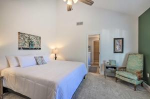 a bedroom with a white bed and a chair at Charming Newnan Getaway about Mins to Downtown! in Newnan