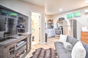 a living room with a couch and a kitchen at Adorable Studio Cottage Walkable to Town! in Grants Pass