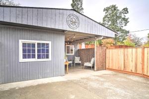 a house with a garage with a fence at Adorable Studio Cottage Walkable to Town! in Grants Pass