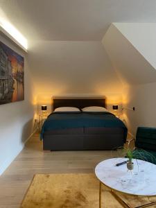 a bedroom with a bed and a table in it at Villa-Stern in Keutschach am See