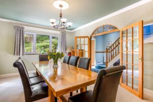 a dining room with a wooden table and chairs at Seahaven in Torquay