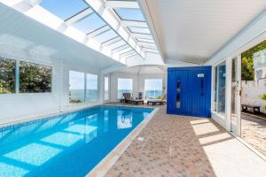 a swimming pool in a house with an open ceiling at Seahaven in Torquay