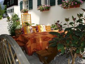 einen Tisch und Stühle mit einem Tisch und Blumen in der Unterkunft Ferienhaus Büsch in Gaschurn