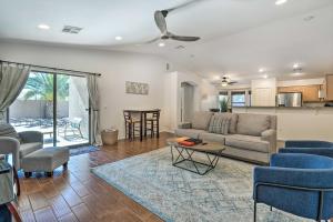 a living room with a couch and a table at Avondale Home with Pool, 5 Mi to State Farm Stadium! in Avondale