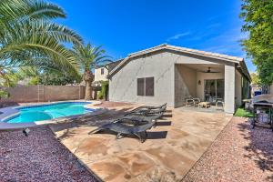 a backyard with a swimming pool and a house at Avondale Home with Pool, 5 Mi to State Farm Stadium! in Avondale