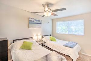 two beds in a room with a ceiling fan at Vibrant, Colorful Tucson Abode w/ Pool & Hot Tub in Tucson +24 photos