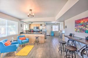 a living room with blue chairs and a kitchen at Vibrant, Colorful Tucson Abode w/ Pool & Hot Tub in Tucson