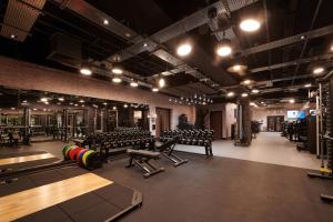 a gym with benches and equipment in a room at Cameron House Lodges in Balloch