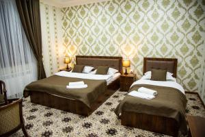 a hotel room with two beds in a room at Gala Osiyo Samarkand in Samarkand