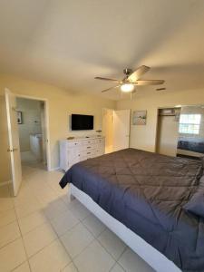 een slaapkamer met een bed en een plafondventilator bij Beachy Sarasota Duplex in Sarasota