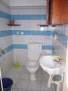 a bathroom with a toilet and a sink at The Rock Garden Apartments in Amdalai