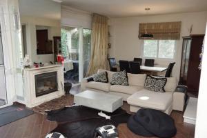 a living room with a couch and a fireplace at Villa Vasili in Tríkala