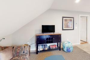 a living room with a couch and a flat screen tv at Londonderry Retreat in Londonderry