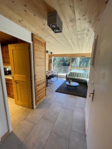 a living room with a couch and a table at Résidence LE ROC SABAL - Courchevel 1650 in Courchevel