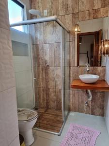 a bathroom with a shower and a toilet and a sink at Casa Praia dos Anjos in Barra Grande