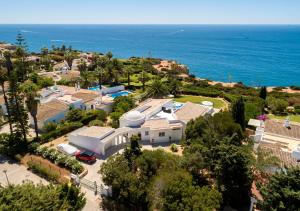 an aerial view of a house with the ocean in the background at Casa Guincho in Carvoeiro