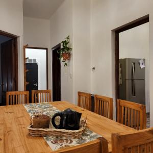 a dining room table with a black tea kettle on it at Casa en San Pedro para 8 totalmente equipada in San Pedro
