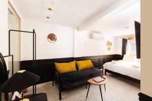 a bedroom with a bed and a couch and a table at The Bold Signature 1BDR Studio Cairo's Downtown 21B in Cairo