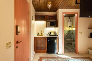 a kitchen with a black refrigerator and a microwave at Marrakesh 1BDR w Jacuzzi Terrace Downtown Cairo in Cairo