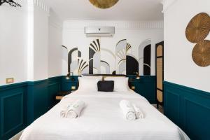 a bedroom with a large bed with shoes on it at The Neat Nostalgic 2BDR Apt Cairo's Downtown in Cairo