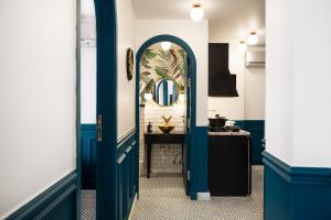 um corredor com uma porta azul e um espelho em The Neat Nostalgic 2BDR Apt Cairo's Downtown no Cairo