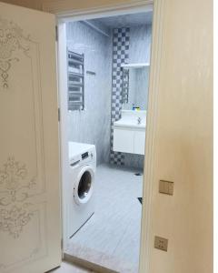 a bathroom with a washing machine and a sink at 3 комнатная VIP квартира возле метро in Baku