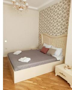 a bedroom with a bed with two towels on it at 3 комнатная VIP квартира возле метро in Baku