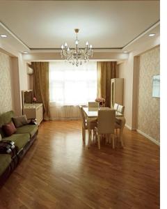 a living room with a table and a dining room at 3 комнатная VIP квартира возле метро in Baku