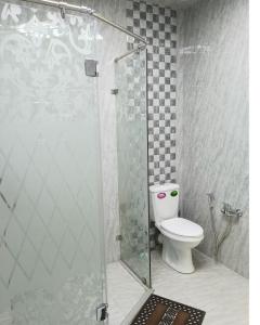 a bathroom with a toilet and a glass shower at 3 комнатная VIP квартира возле метро in Baku