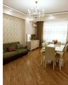 a living room with a couch and a table at 3 комнатная VIP квартира возле метро in Baku