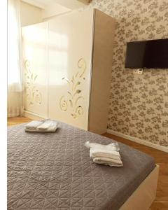 a bedroom with a bed with two towels on it at 3 комнатная VIP квартира возле метро in Baku