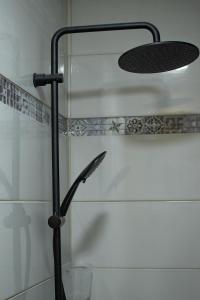 a shower with a shower head in a bathroom at Appart 'Caraibe Résidence MARINE HOTEL in Le Diamant